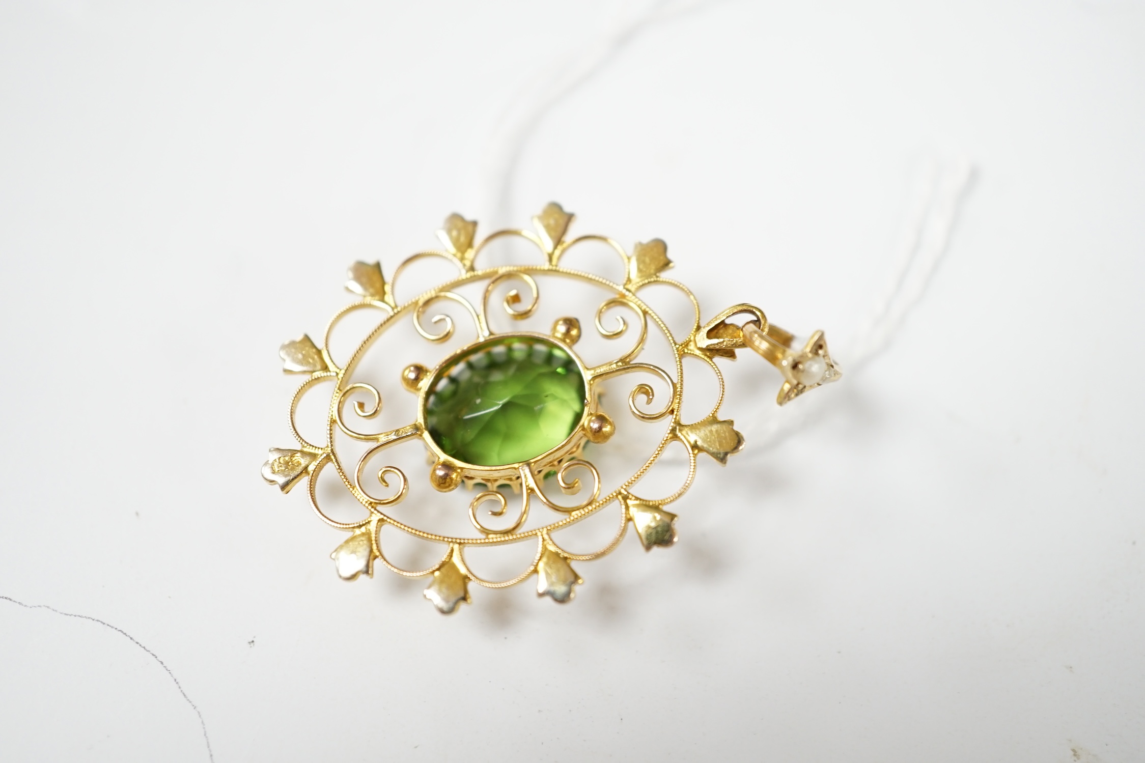 An early 20th century style 9ct, green paste and seed pearl set oval open work pendant, 38mm, 3.5 grams. Condition - good